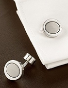 Simple, sophisticated cufflinks in brushed rhodium. Polished orbs with a textured oval inside. Imported.